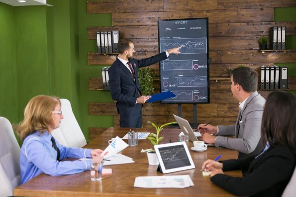 businessman-suit-having-presentation-with-charts-tv-screen-conference-rom-team-meeting_482257-31223